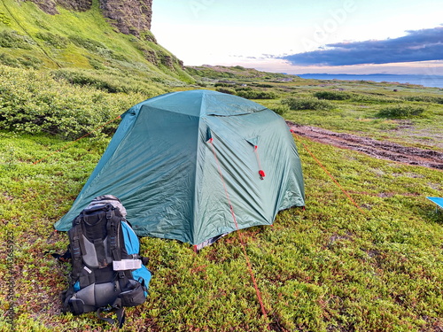 Tent and backpack in a tourist camp, Murmansk region of Russia.