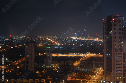 Downtown Dubai cityscape, skyscrapers cluster during the night from the outskirts. 