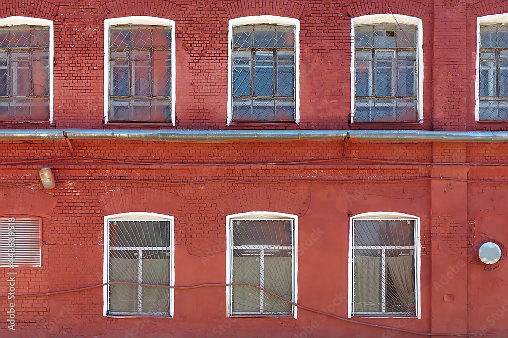 A fragment of the facade of an old multi-story brick building