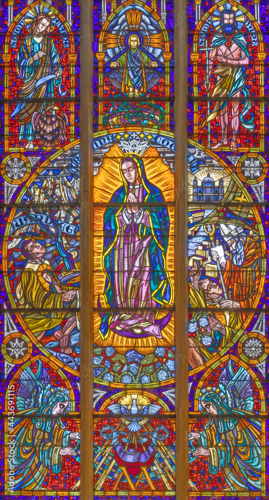 VIENNA, AUSTIRA - JUNI 24, 2021: The  Immaculate Conception of Virgin Mary from Guadalupe on the stained glass in the Votivkirche church originaly by by Hans Schweiger (1963).