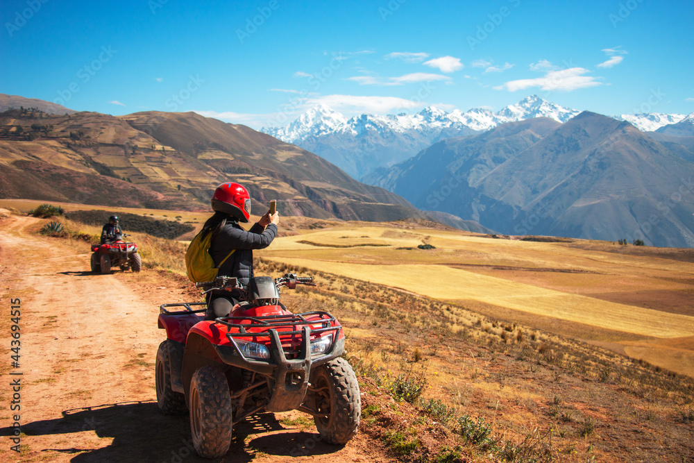 biker in the mountains taking pictures of a beautiful view biker in the mountains taking pictures of a beautiful view