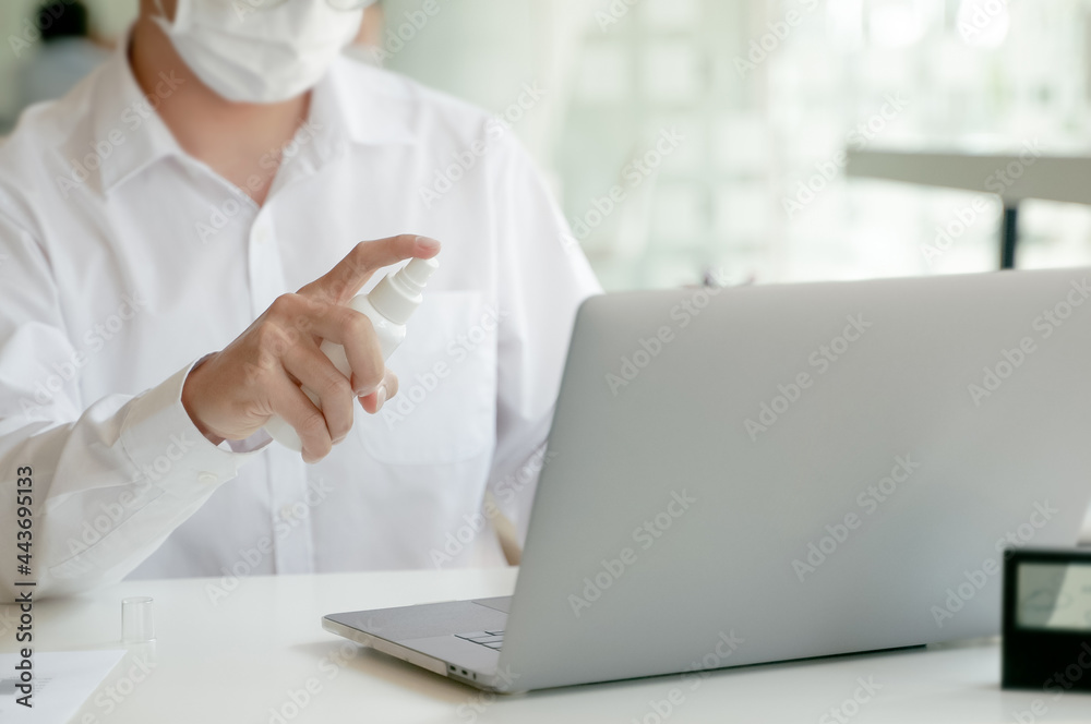 business people disinfectant spray Sanitize surfaces prevention in office.