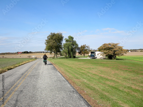 Man riding bike on country road