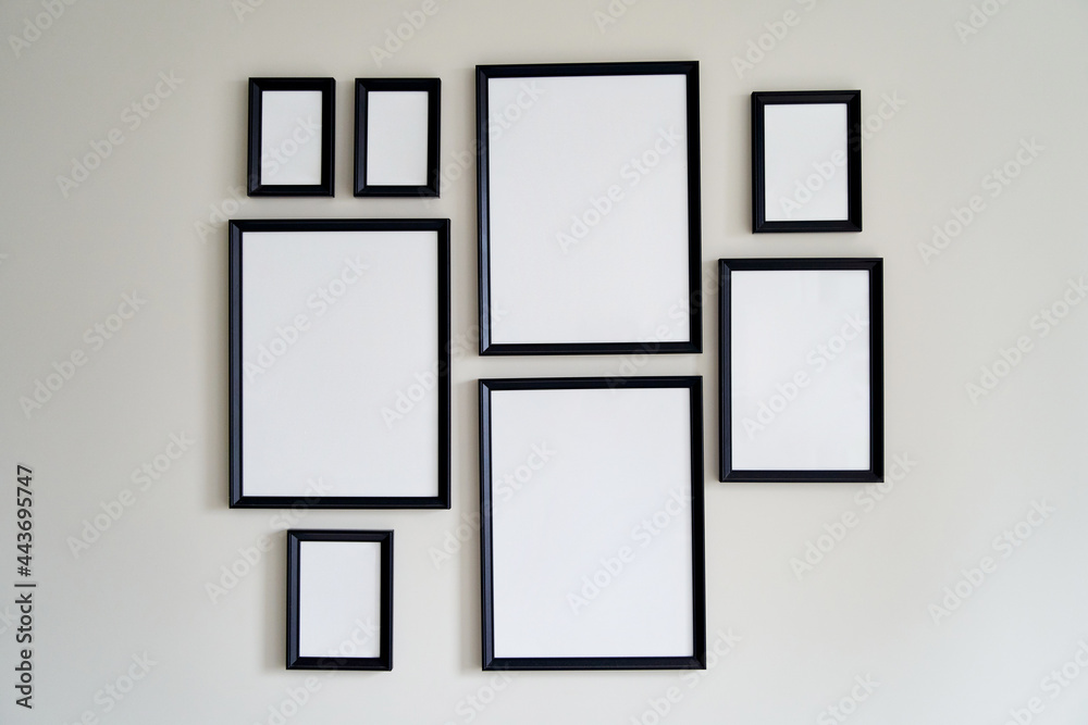 Different size framed photos hanging on the gray wall. Mockup. Different size framed photos hanging on the gray wall. Mockup.