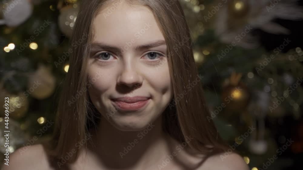 Happy young woman on the background of a dressed up Christmas tree. Christmas portrait of a beautiful woman. Slow motion, HD. Happy young woman on the background of a dressed up Christmas tree. Christmas portrait of a beautiful woman. Slow motion, HD.