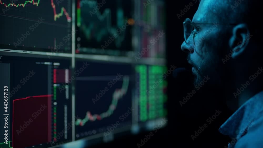 Trader is working with multiple computer screens with charts and data analysis and stock broker trading online. Concept of bitcoin and ethereum blockchain trading. Businessman is checking market data