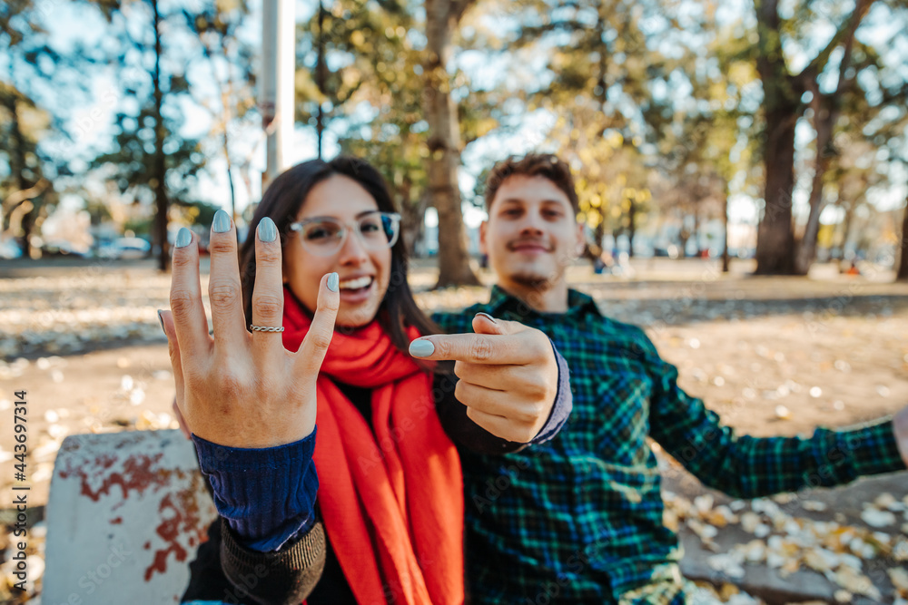 marriage proposal in a park, a young couple marriage proposal in a park, a young couple