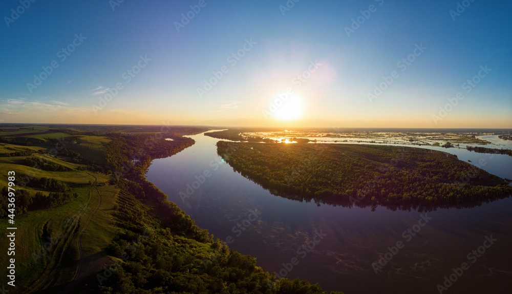 Aerial drone view of river landscape in sunny summer evening