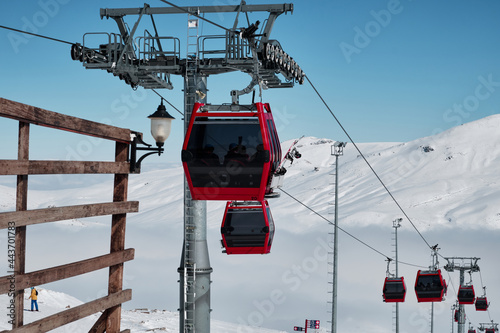 Gondola type ropeway on the slope of ski resort above clouds. Erciyes ski resort. Kayseri, Turkey photo