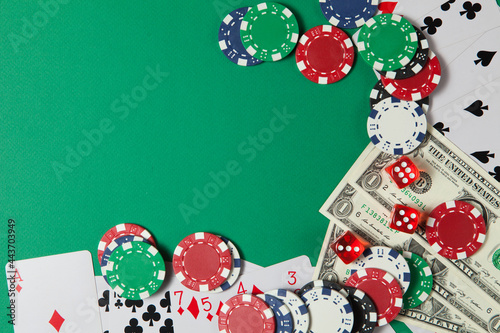 Classic playing cards, chips, red dice and dollars on green background. Gambling and casino concept.