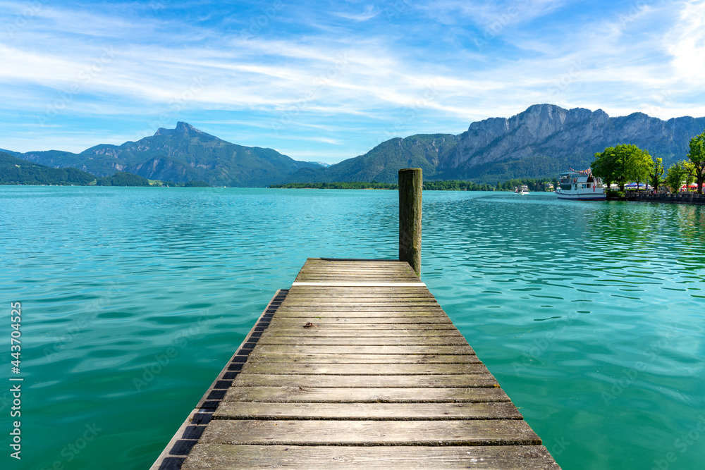 Mondsee with mountains view from a wooden rustic dock pier