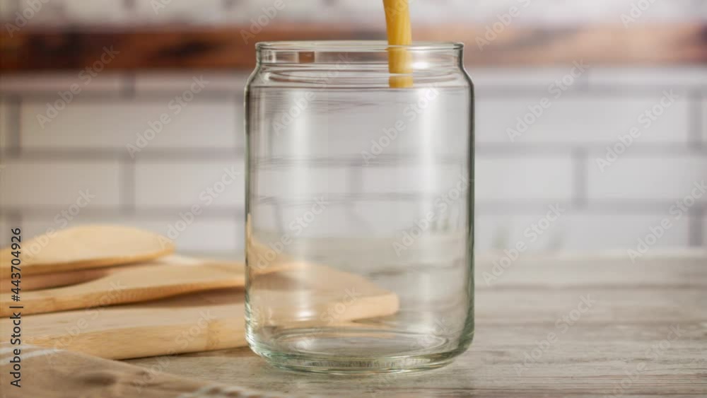 Close up shot of pasta falling into a jar in slow motion Close up shot of pasta falling into a jar in slow motion