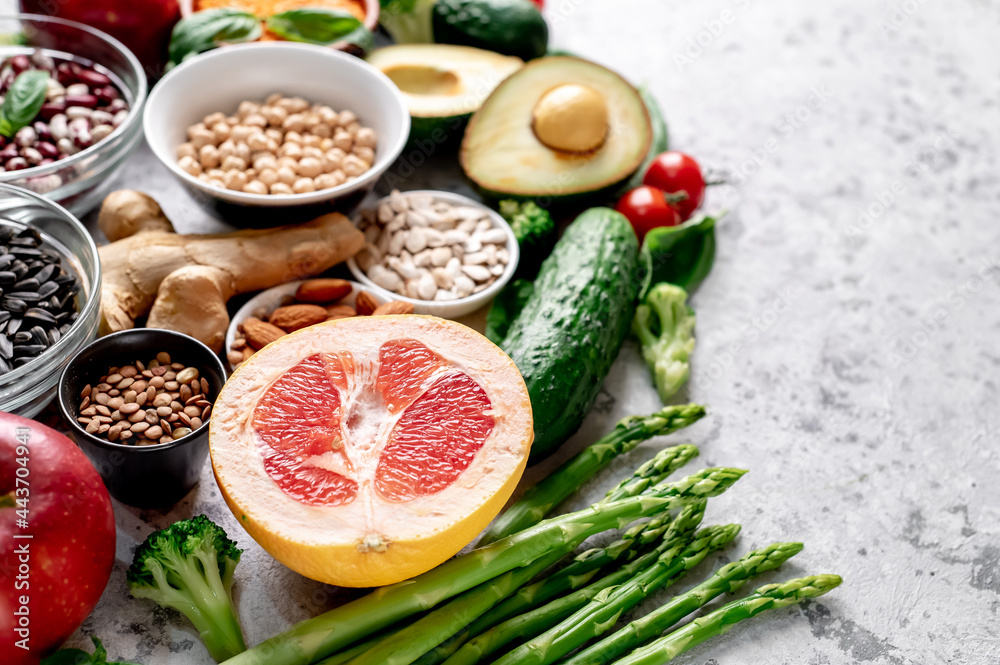 Fresh fruits, vegetables and seeds. Healthy food on a light stone background with copy space for your text Fresh fruits, vegetables and seeds. Healthy food on a light stone background with copy space for your text