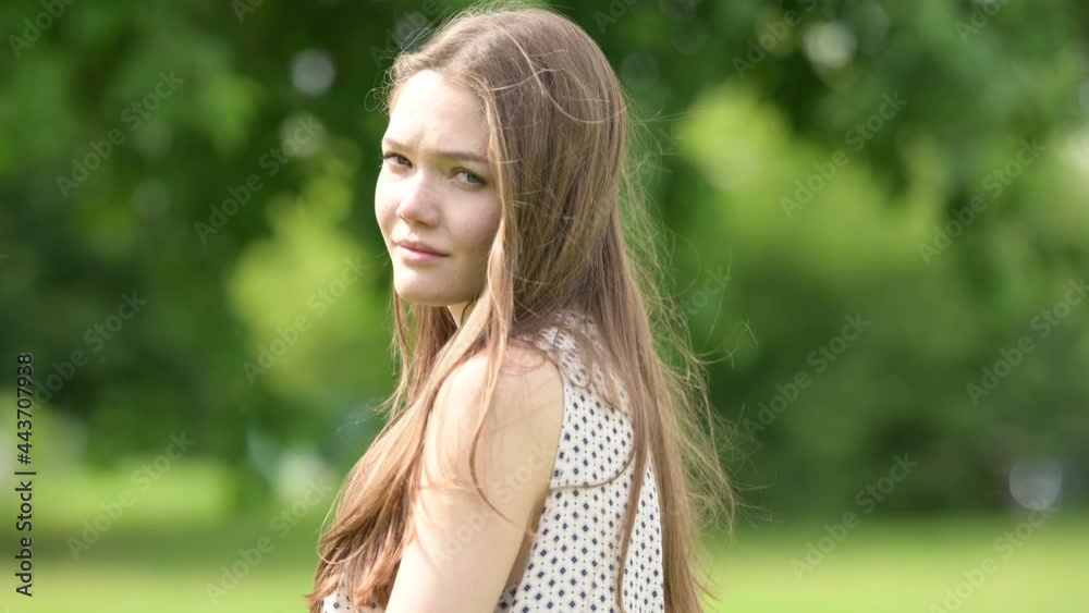 Attractive young teen girl walks in nature on a sunny day. Portrait of gorgeous girl posing and looking to camera. People style concept Attractive young teen girl walks in nature on a sunny day. Portrait of gorgeous girl posing and looking to camera. People style concept