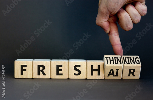 Fresh thinking and air symbol. Businessman turns wooden cubes, changes words fresh thinking to fresh air. Beautiful grey background. Copy space. Business, ecological, fresh thinking and air concept.