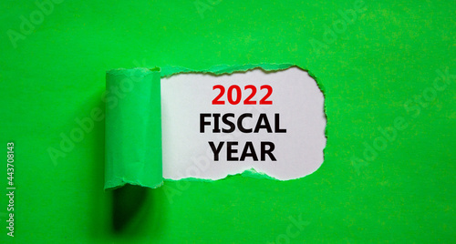 2022 fiscal new year symbol. Words '2022 fiscal year' appearing behind torn green paper. Beautiful green background. Business, 2022 fiscal new year concept, copy space.