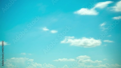 The white clouds in the sky move beautifully and softly, shot with Time Lapse in a tall building. The view is slightly tilted up against the clouds.