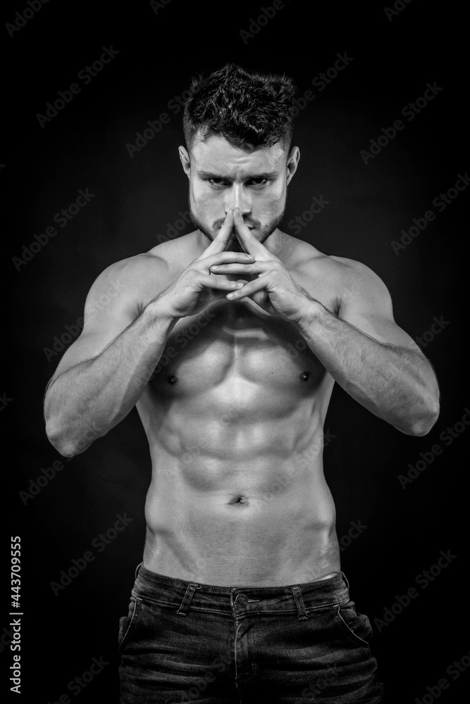 Fototapeta premium Young strong man on dark background