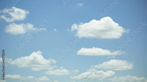 The white clouds in the sky move beautifully and softly, shot with Time Lapse in a tall building. The view is slightly tilted up against the clouds.