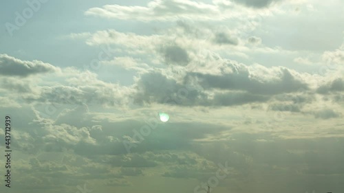 The white clouds in the sky move beautifully and softly, shot with Time Lapse in a tall building. The view is slightly tilted up against the clouds.