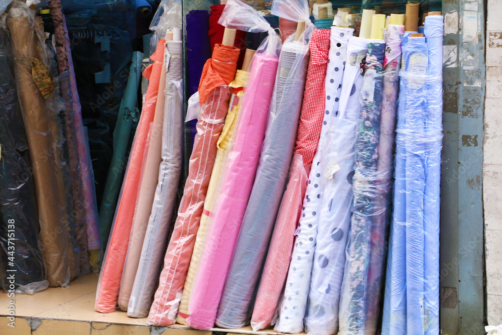 dowry and dress fabrics in accordance with Turkish traditions. bridal fabrics. Colorful fabrics were lined up on the shelves of the fabric store. selective focus
