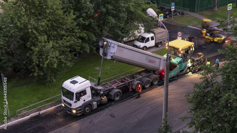 Workers laid asphalt in a residential area,time lapse Workers laid asphalt in a residential area,time lapse