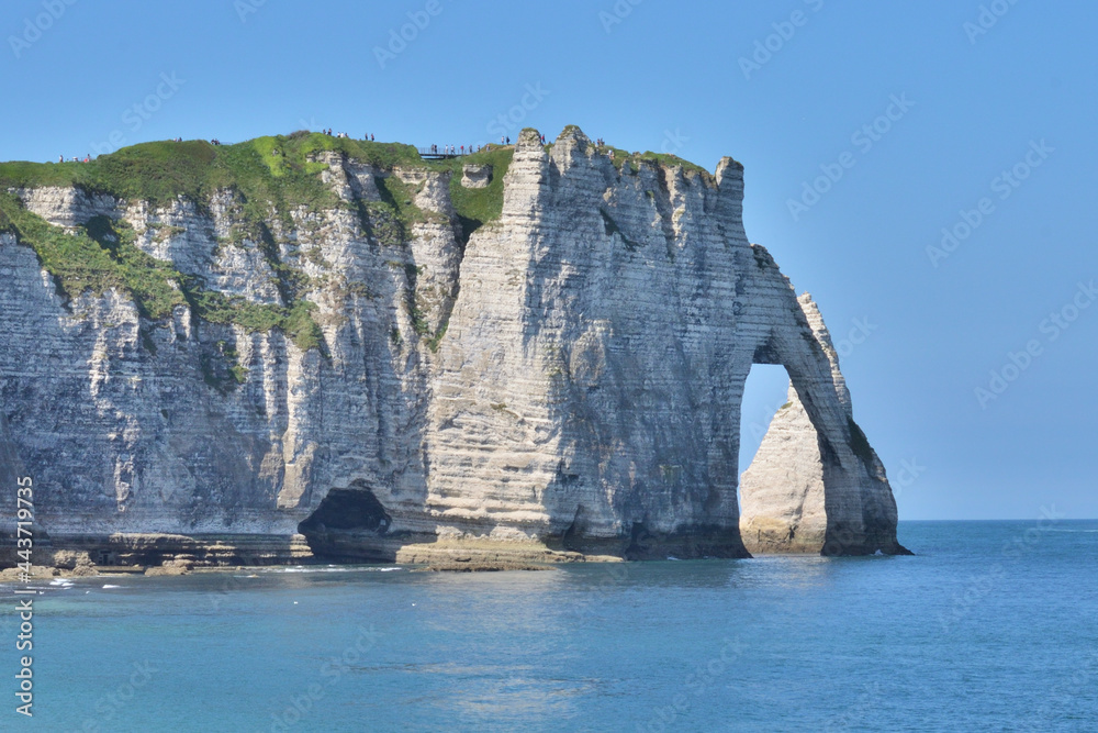Natural arch by the sea in Etretat. Rock formation. Beautiful landscape. Travel in France.