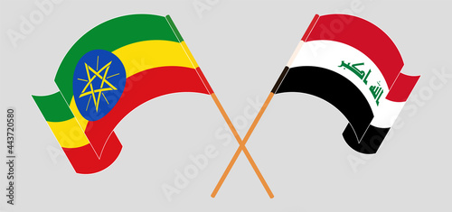 Crossed and waving flags of Ethiopia and Iraq