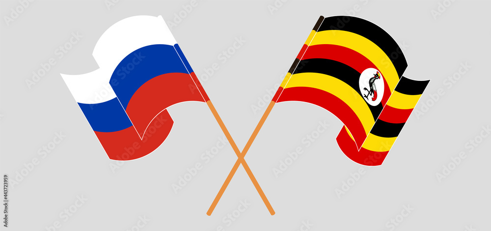 Crossed and waving flags of Russia and Uganda