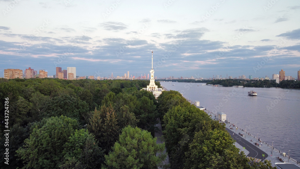 Obraz premium Sunset, river port in Moscow with beautiful nature, ships, containers. Drone view in the evening. Night building with lights.