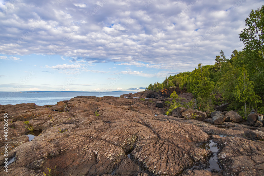 Coastline of Lake Superior with blue sky and white clouds, Michigan, USA