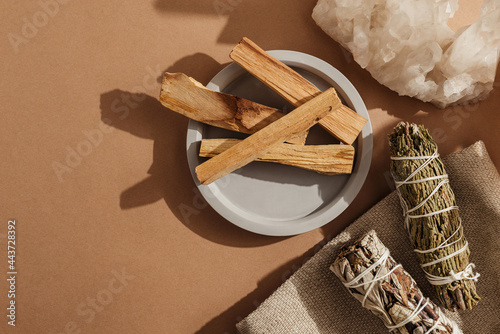 Set of incense for fumigation of premises. Tied in bunch of sprigs of white sage, crystals and sticks of Palo Santo. Top view. Organic holy tree incense from Latin America. Close-up color photo photo