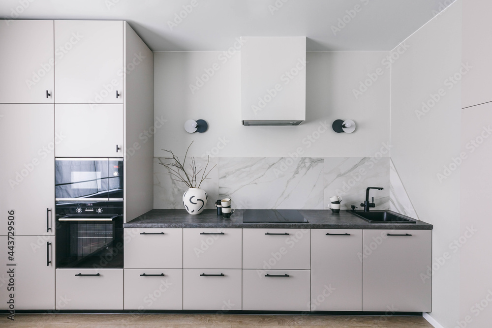 Minimalistic interior kitchen design. White grey marble kitchen room organization