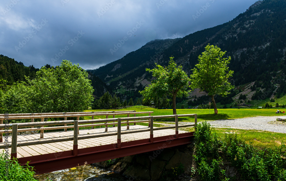 Obraz premium Small wooden bridge to the lake in Vall de Nuria valley Sanctuary in the Catalan Pyrenees, Spain,Europe