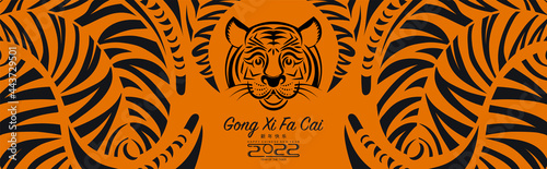 Chinese new year 2022 year of the tiger red and gold flower and asian elements paper cut with craft style on background.( translation : chinese new year 2022, year of tiger )