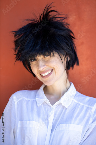 Photography woman with scruffy hairstyle isolated on red background