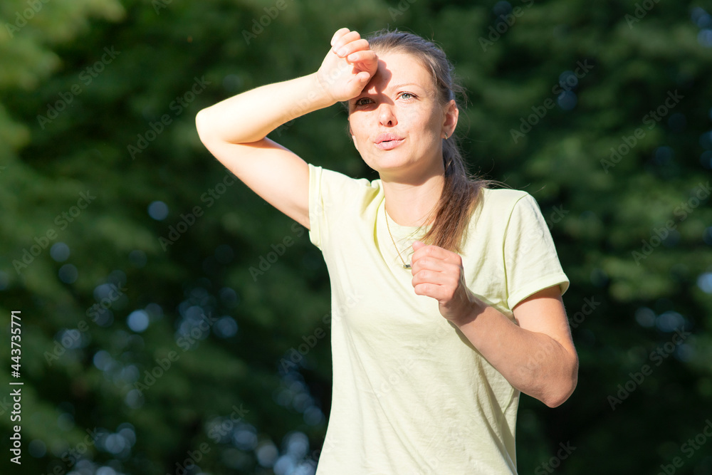 Girl runner is suffering from pain at running, jogging. Heat, woman with heatstroke. Having sunstroke at summer hot weather. Dangerous sun, girl under sunshine. Headache, feeling bad, tired, exhausted Girl runner is suffering from pain at running, jogging. Heat, woman with heatstroke. Having sunstroke at summer hot weather. Dangerous sun, girl under sunshine. Headache, feeling bad, tired, exhausted