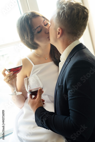 Canvastavla newlyweds in love hug, kiss and drink wine, happiness and anticipation of a happ