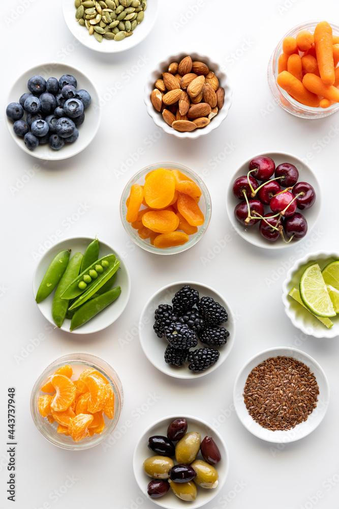 Top down view of small dishes filled with various healthy organic ingredients, against a white background. Top down view of small dishes filled with various healthy organic ingredients, against a white background.