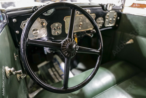 Vintage car interior dash and instruments and steering wheel © BradleyWarren