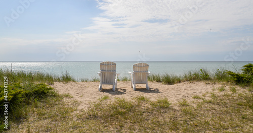 Empty white beach chair along the waterfront