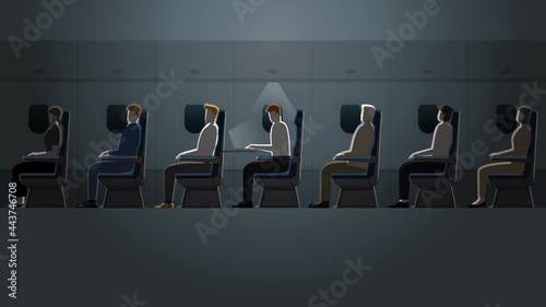 Employee salaryman working alone with laptop notebook while the other passengers are asleep in a plane cabin. A business trip lifestyle of work hard overtime and overwork in the dark and small light.