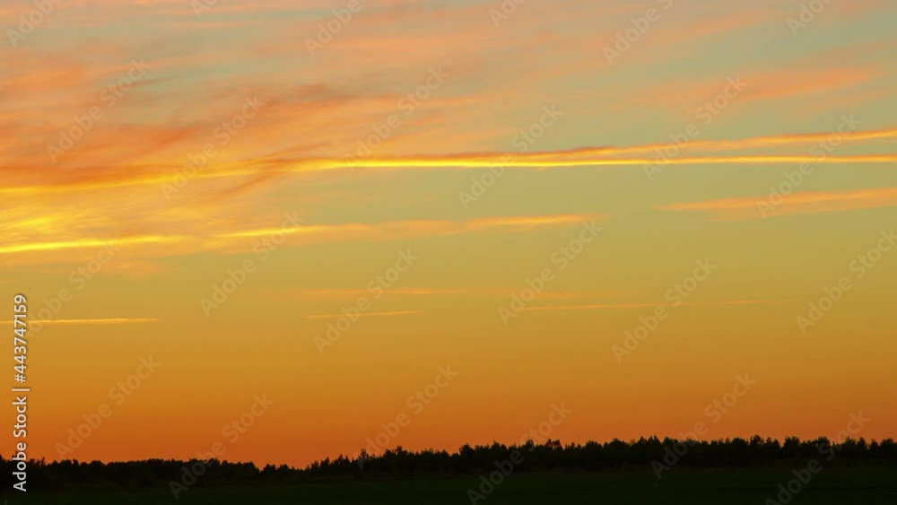 Time-lapse sunset in the field, the sky with clouds turns orange Time-lapse sunset in the field, the sky with clouds turns orange