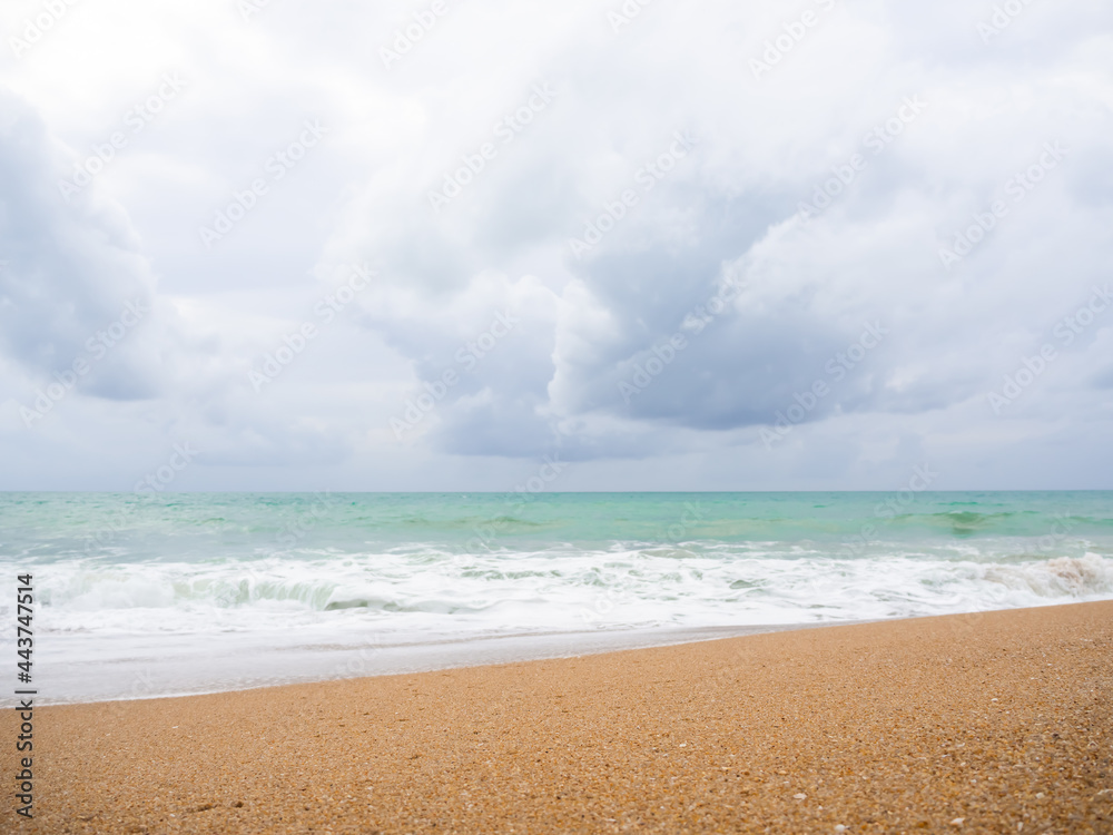 Fototapeta premium Sand beach at coast with blur splash wave blue sea and blue sky on light day. wonderful Phuket island thailand. ocean nature landscape outdoor. tropical tourist summer holidays travel concept.