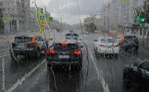 Driving a car around the city during heavy rain. blurred focus