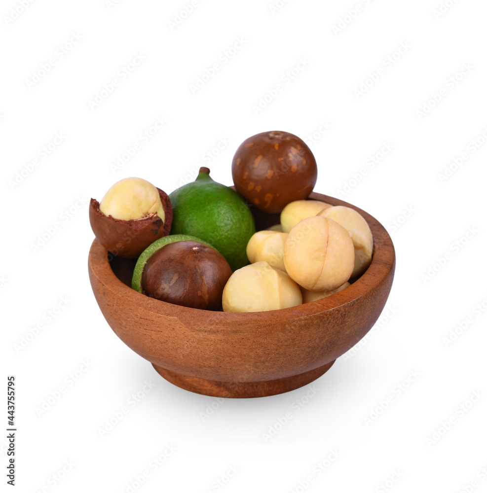 macadamia nuts in wooden bowl isolated on white background. macadamia nuts in wooden bowl isolated on white background.