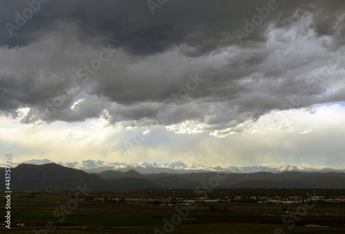 ominous afternoon storm clouds over the colorado rocky mountains as seen from Broomfield, colorado 
