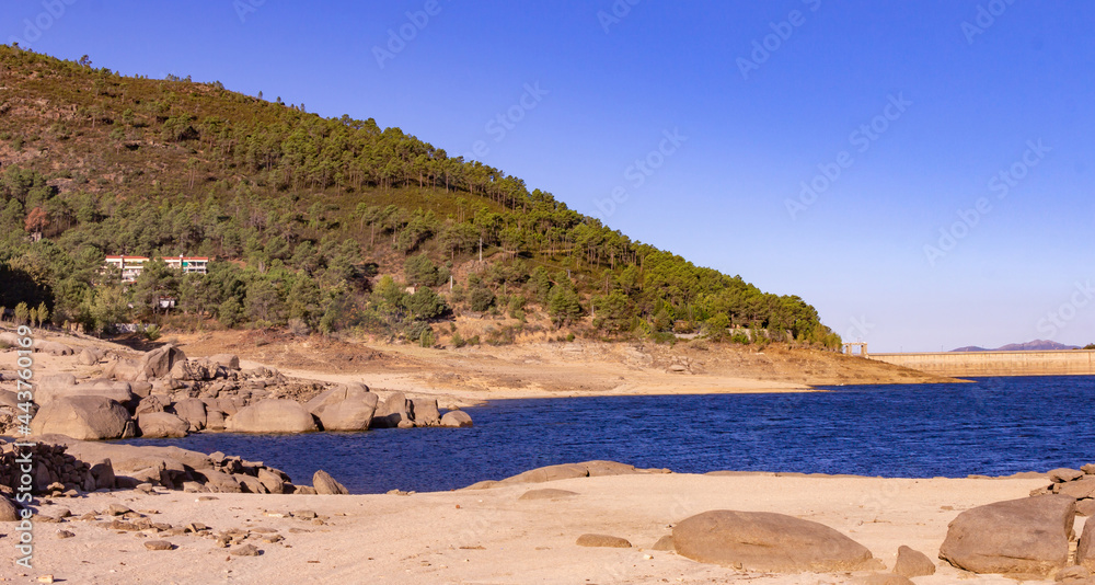 Mountain landscape with a lake, beach and a dam. Mountain landscape with a lake, beach and a dam.