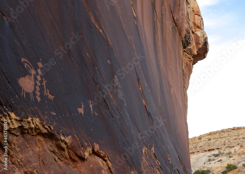  ancient native american  petroglyphs depicting a dog, big horn sheep, and footprints along the spirit arch trail in the black dragon wash in the san rafael swell near green river, utah        