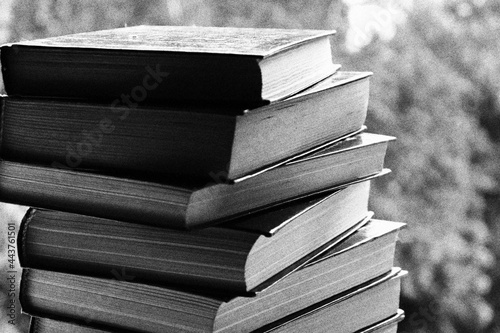a stack of books in close-up against the background of the street